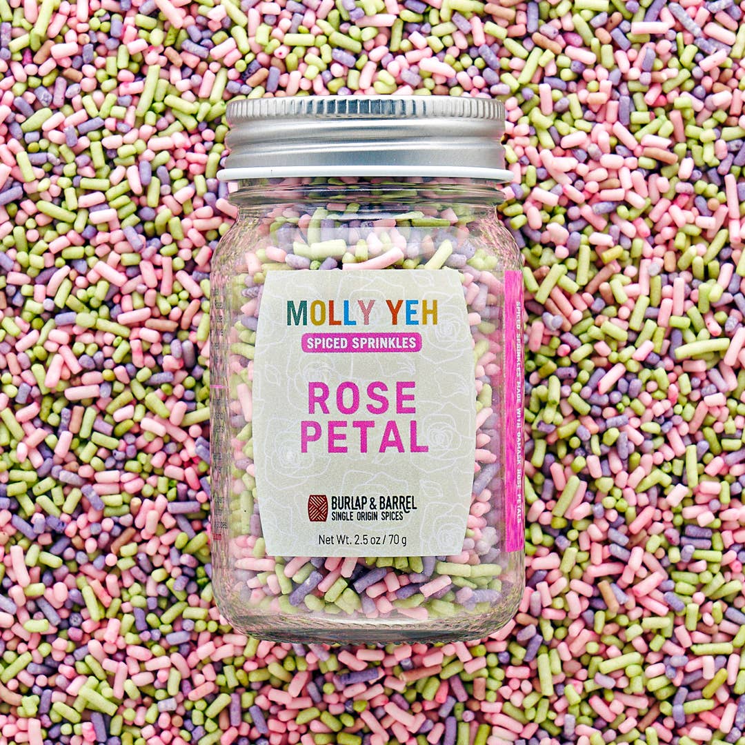 Jar of Molly Yeh Rose Petal sprinkles surrounded by colorful sprinkles