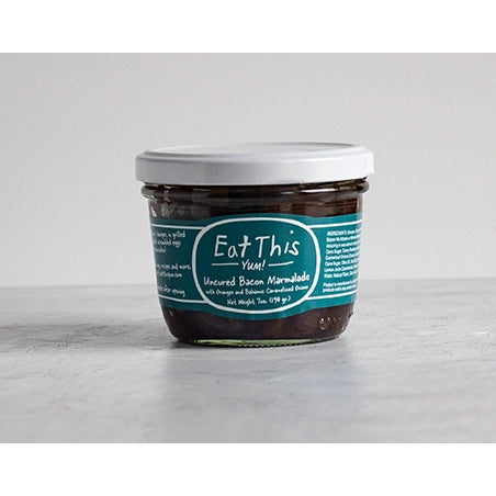 Jar of 'Eat This' brand marmalade on a gray surface