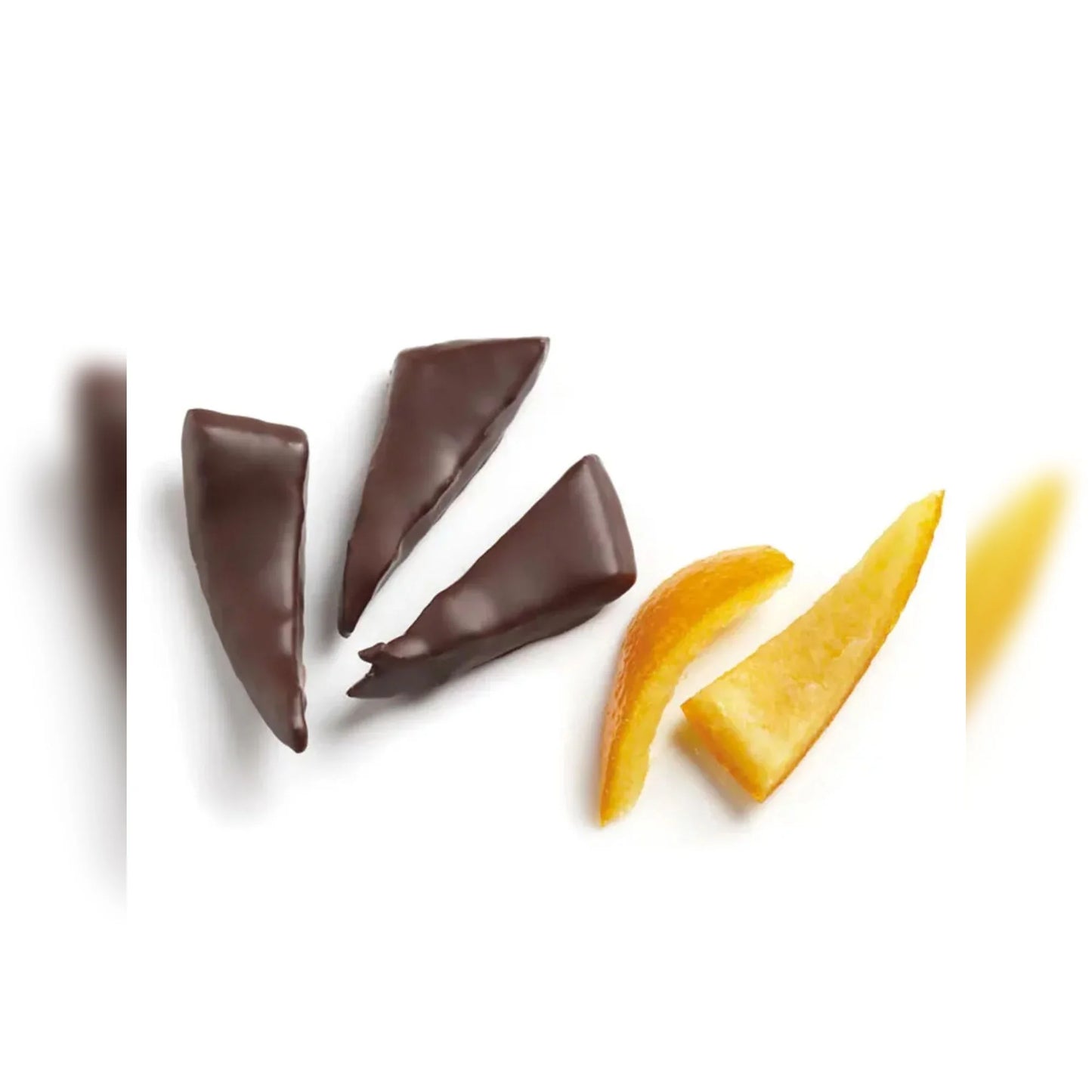 Chocolate and yellow candy pieces on a white background