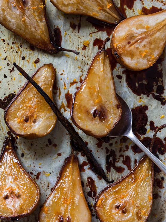 Roasted pears with vanilla beans on a baking tray
