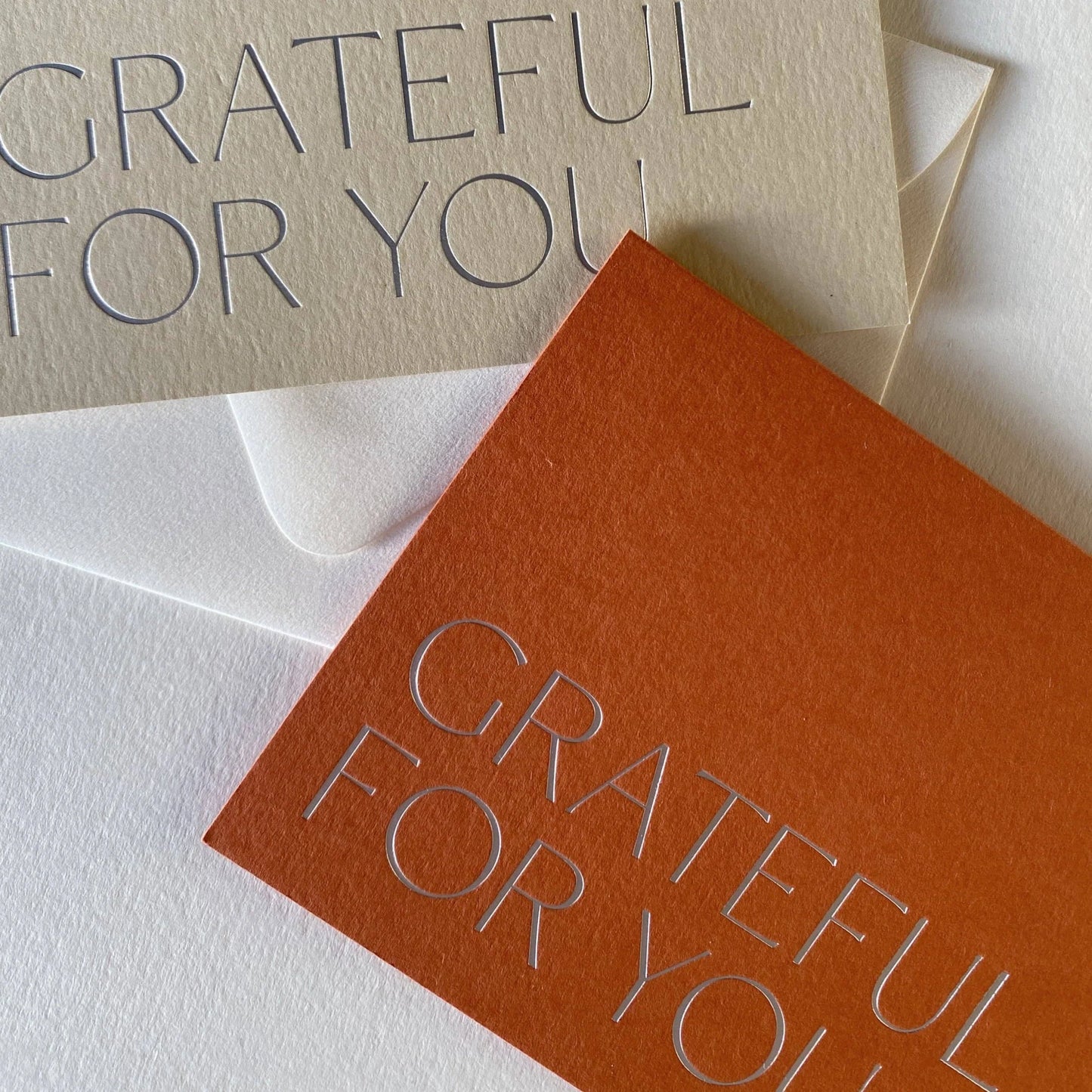 Two greeting cards with 'GRATEFUL FOR YOU' text on beige and orange backgrounds.