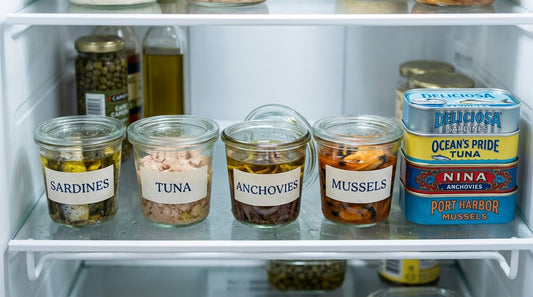 Opened tinned fish transferred to covered glass containers in a refrigerator