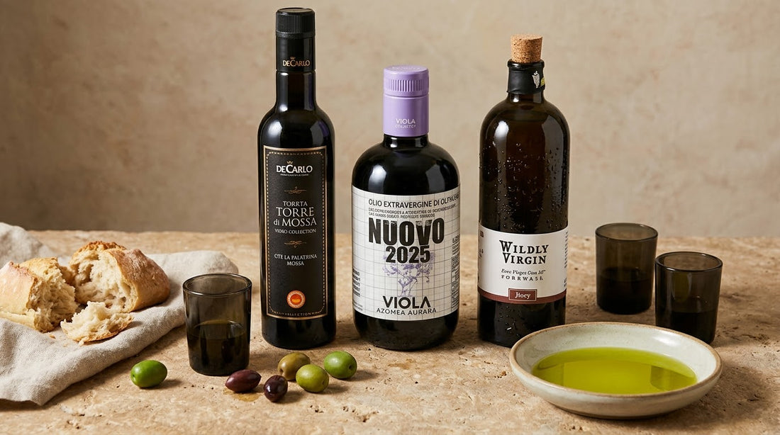 Selection of extra virgin olive oils with green olives, bread and tasting glasses