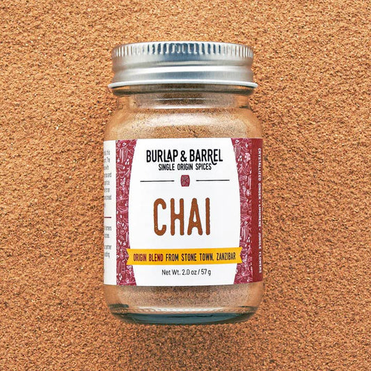 Jar of Burlap & Barrel Chai spice blend on a brown textured background