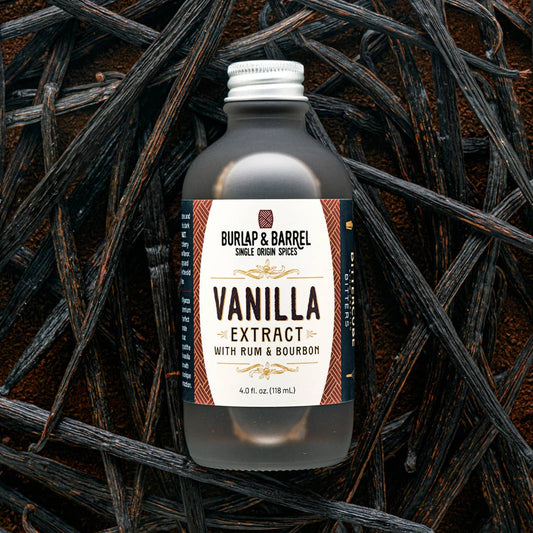 Bottle of Burlap & Barrel Vanilla Extract with Rum & Bourbon on a dark background