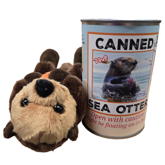 Plush sea otter toy next to a can labeled 'Canned Sea Otter' on a white background
