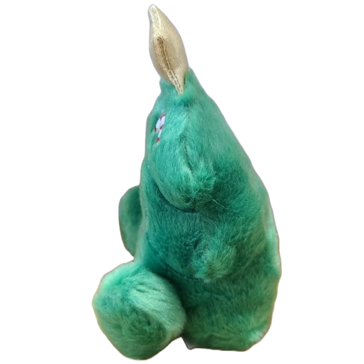 Green plush toy with a gold horn on a white background