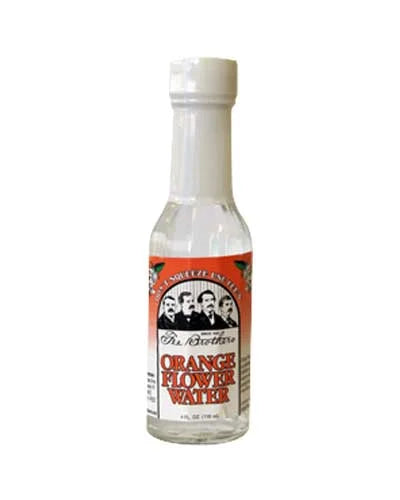 Bottle of orange flower water with a label featuring faces on a white background