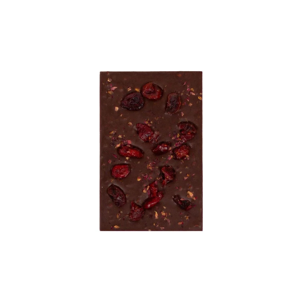 Dark chocolate bar with dried berries on a white background