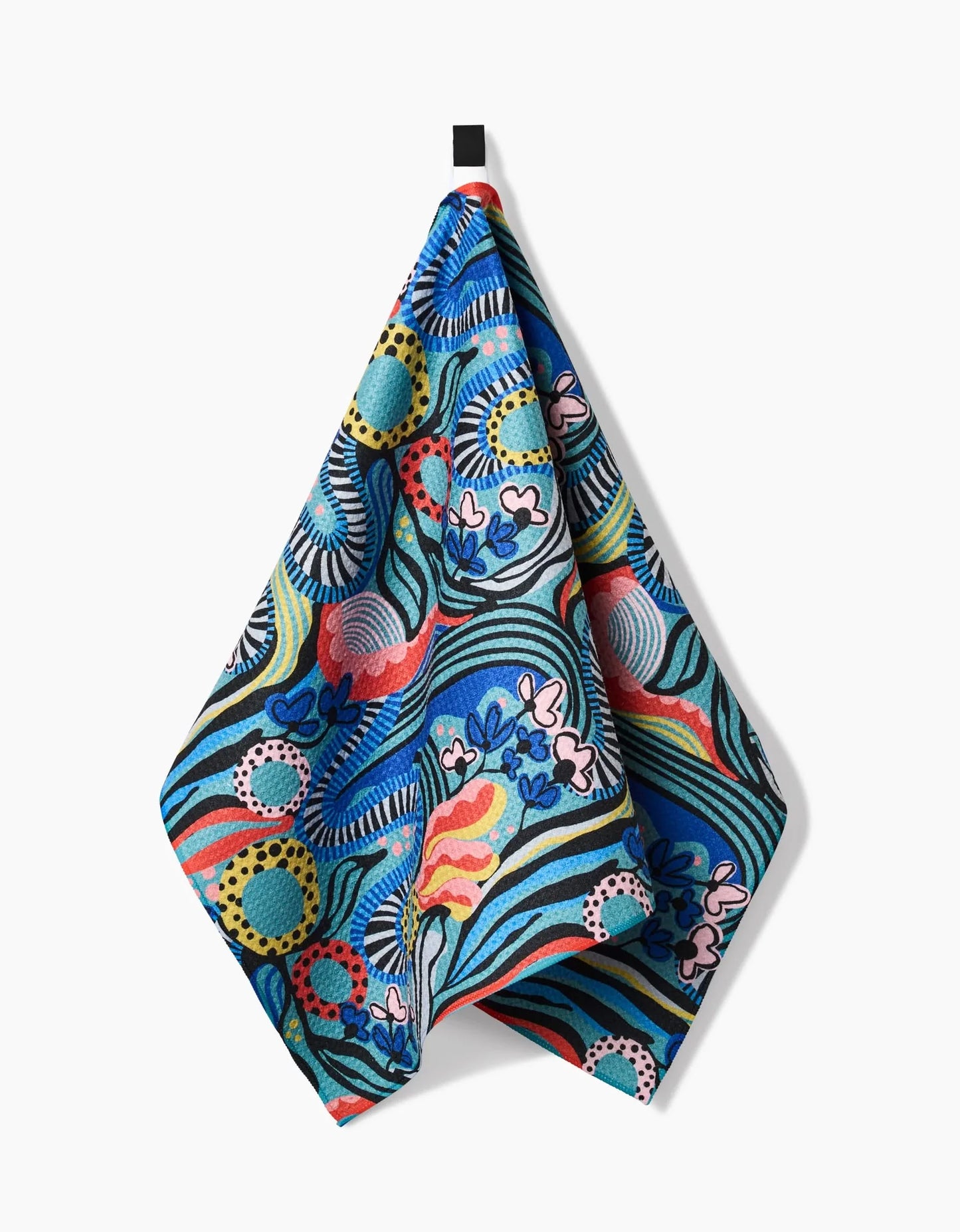Colorful patterned towel hanging on a white background