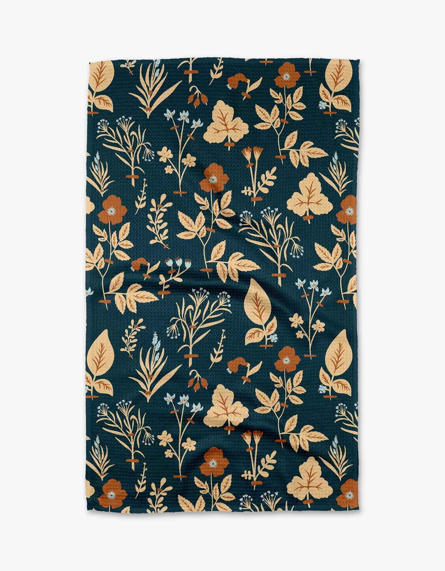 Floral patterned fabric with leaves and flowers on a dark blue background