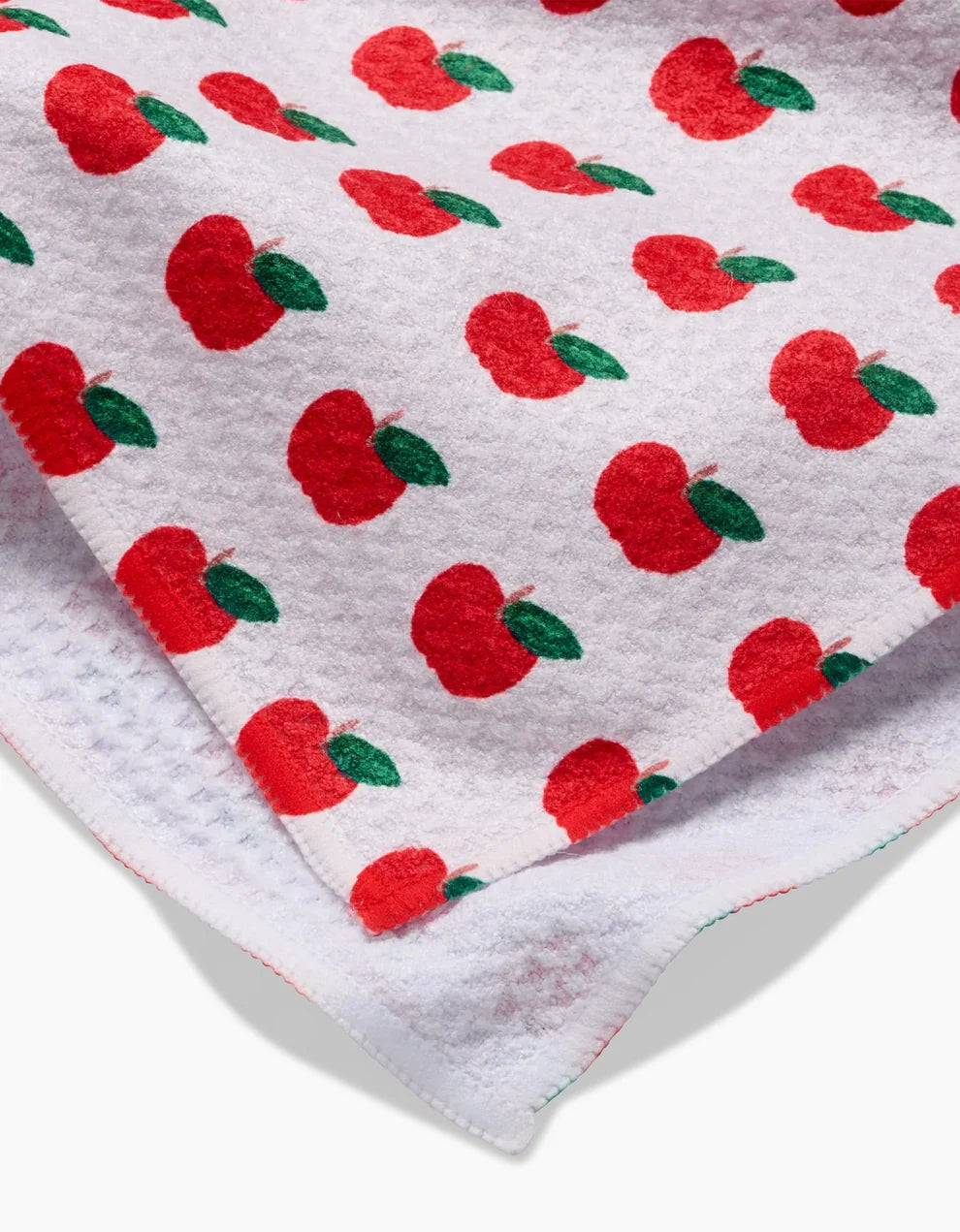 Fabric with red apple pattern on a white background