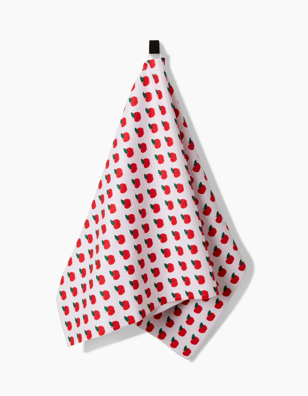 White towel with red apple pattern on a white background