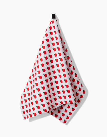 White towel with red apple pattern on a white background