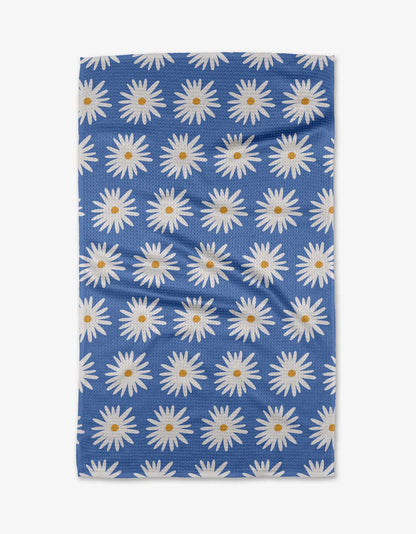 Blue fabric with white daisy pattern on a white background