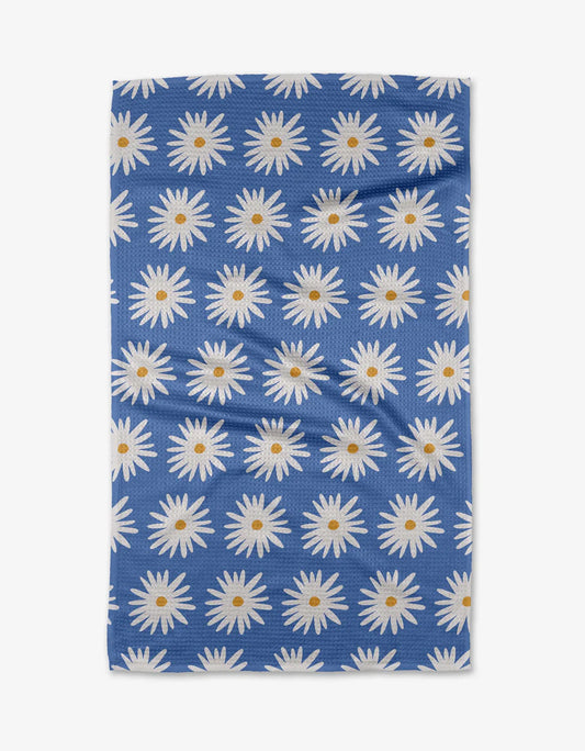Blue fabric with white daisy pattern on a white background