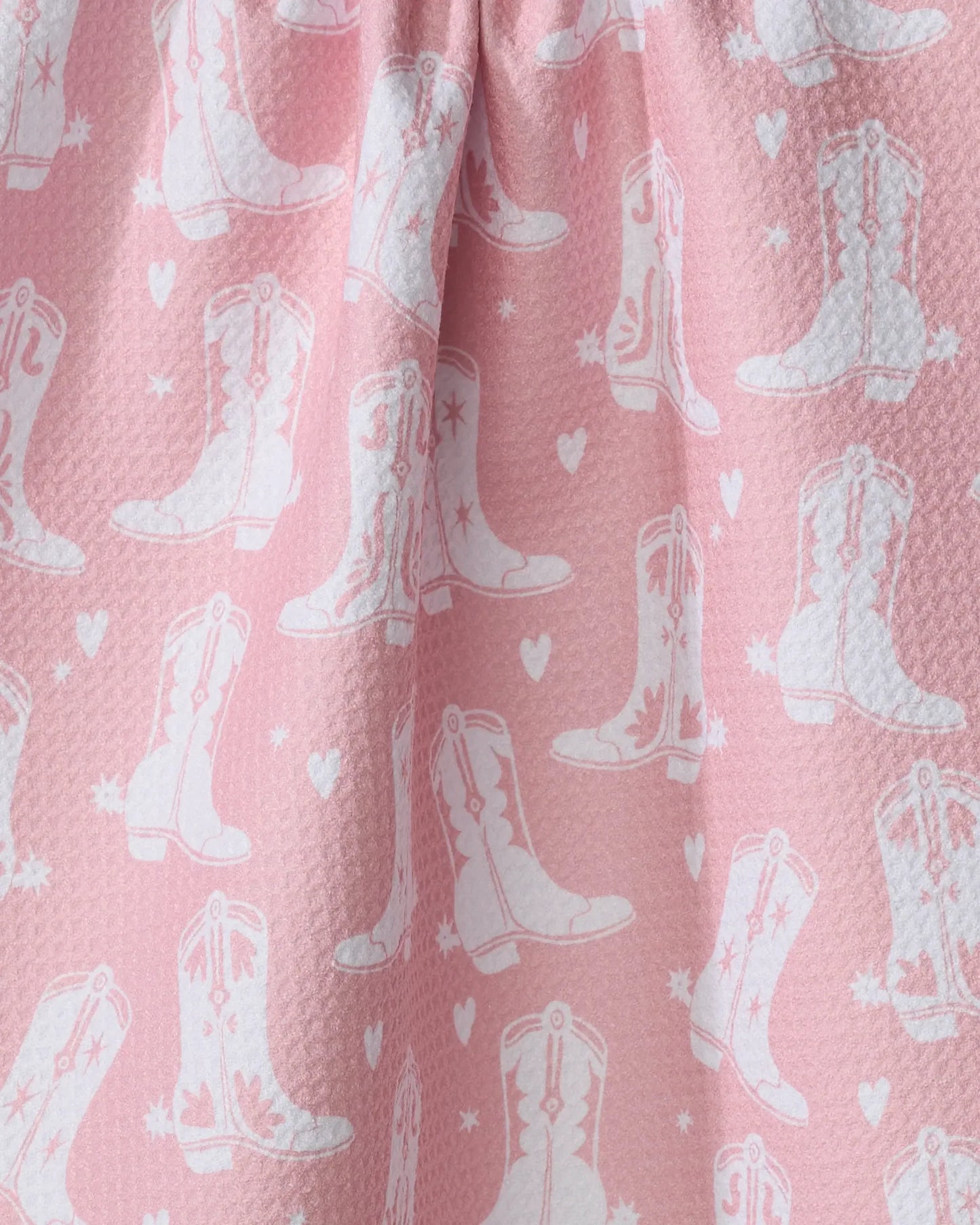 Pink fabric with white cowboy boot pattern