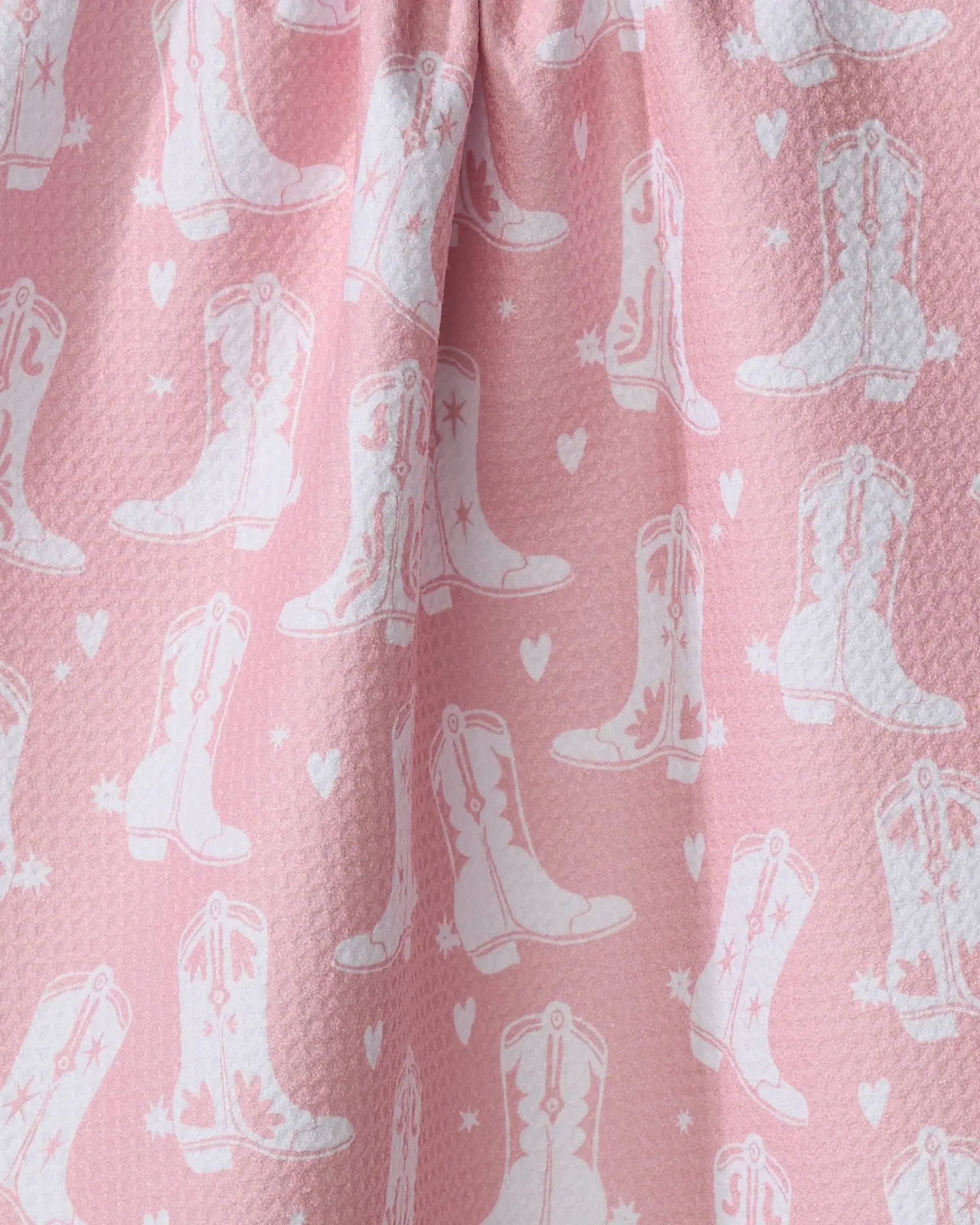 Pink fabric with white cowboy boot pattern