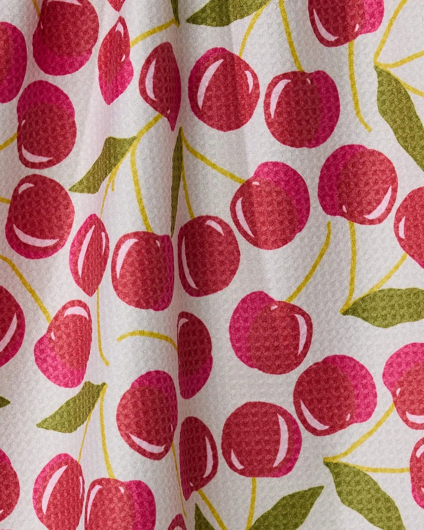 Fabric with red cherry pattern on a white background