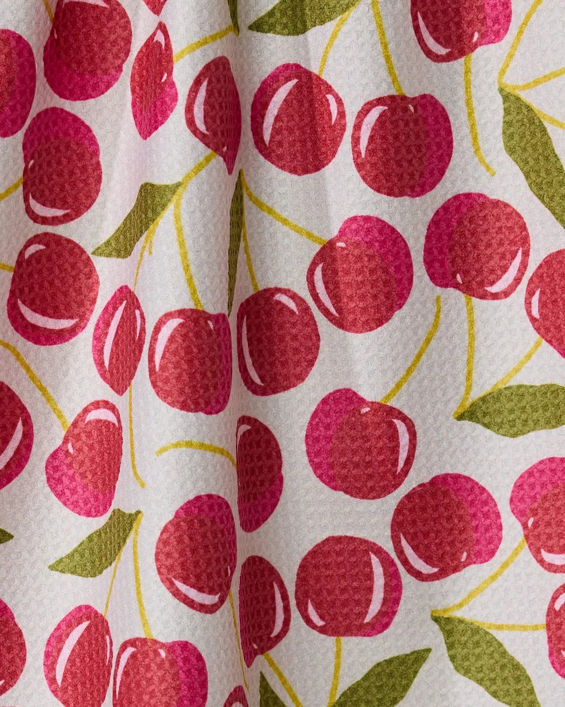 Fabric with red cherry pattern on a white background