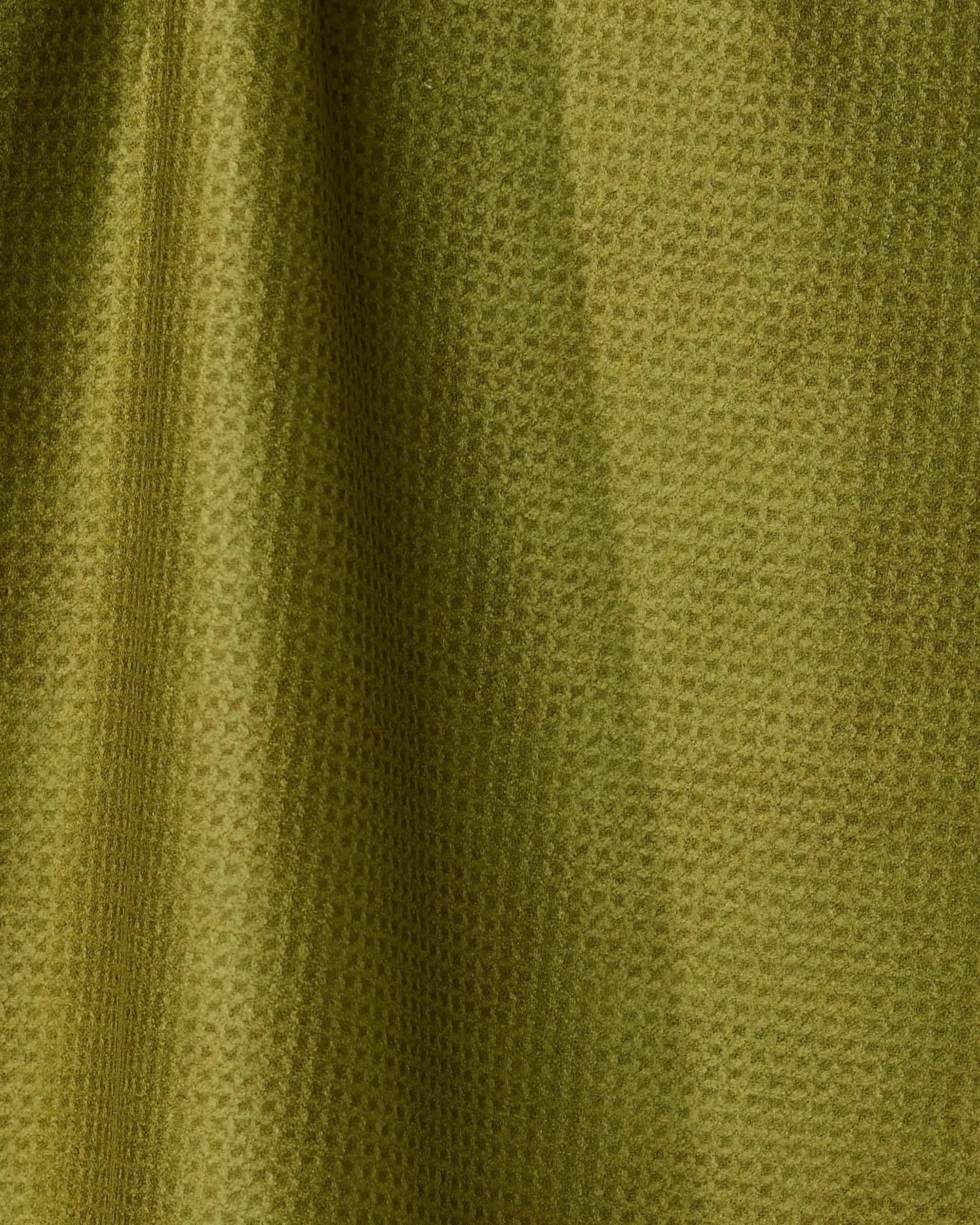 Close-up of green fabric with a subtle pattern