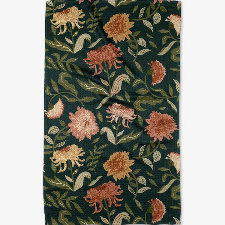 Floral patterned fabric with flowers and leaves on a dark green background