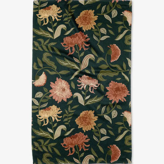 Floral patterned fabric with flowers and leaves on a dark green background