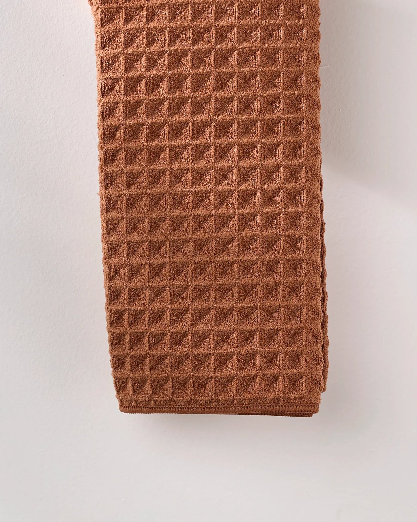 Brown textured tie on a light gray background