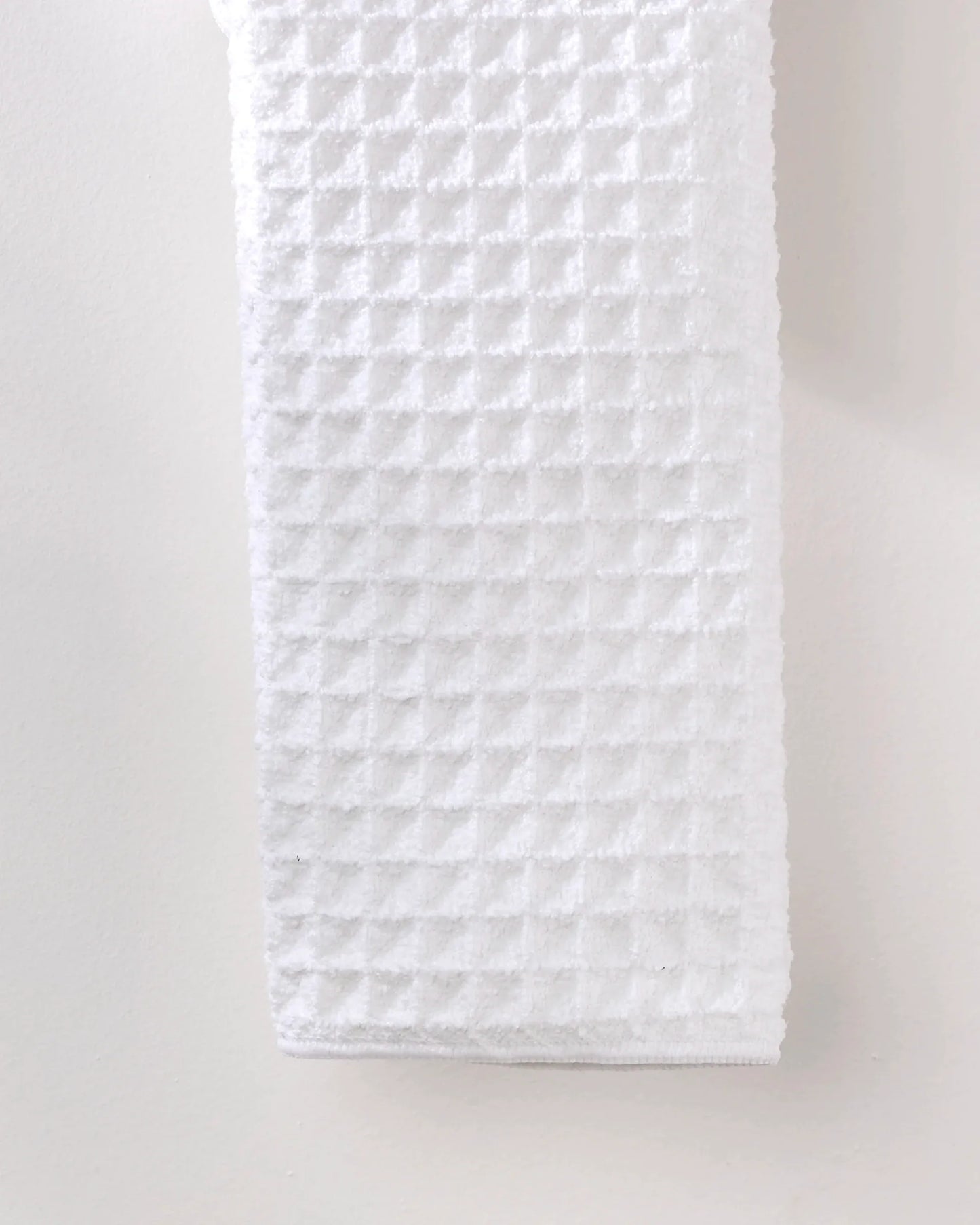 White quilted fabric on a light gray background