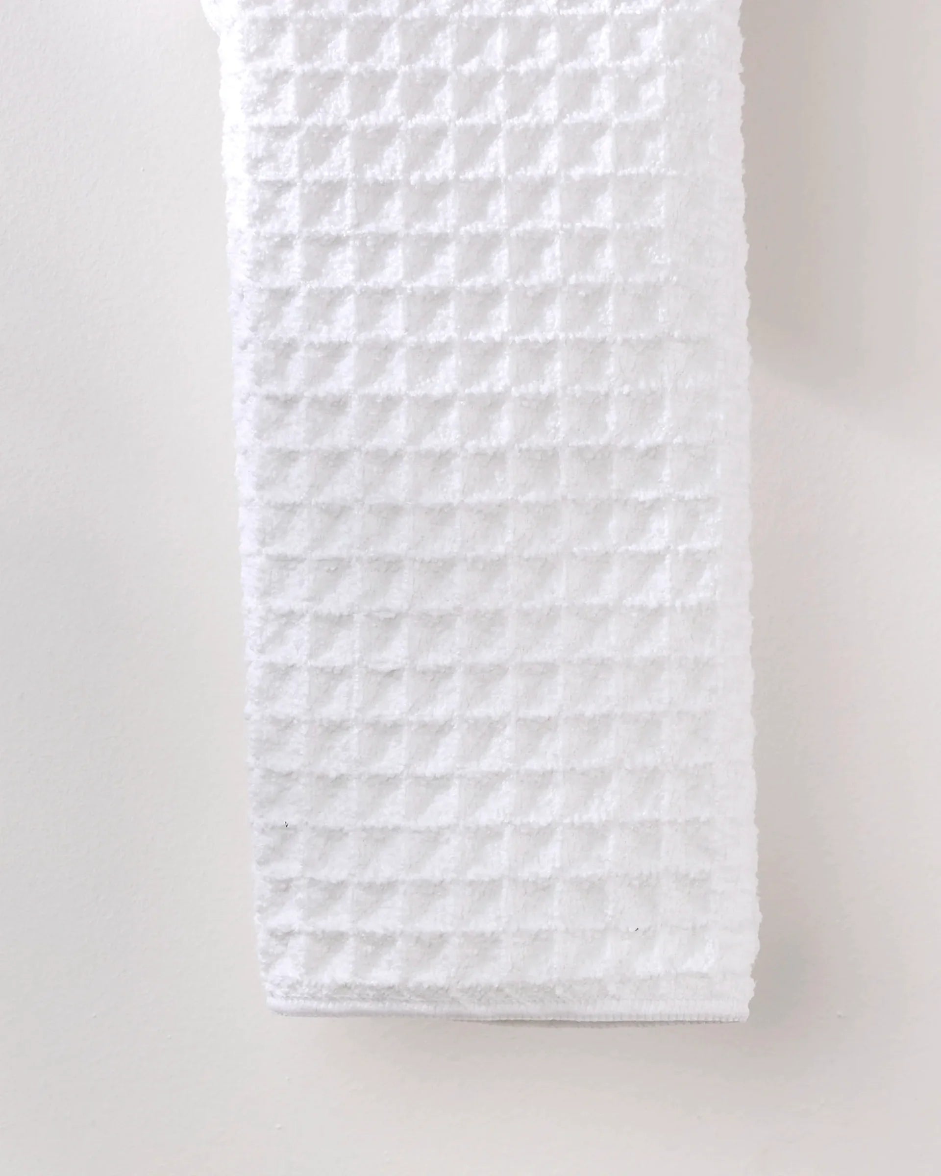 White quilted fabric on a light gray background