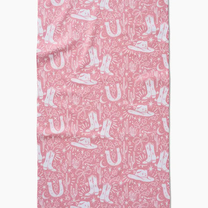 Pink fabric with white cowboy boot, hat, and cactus pattern