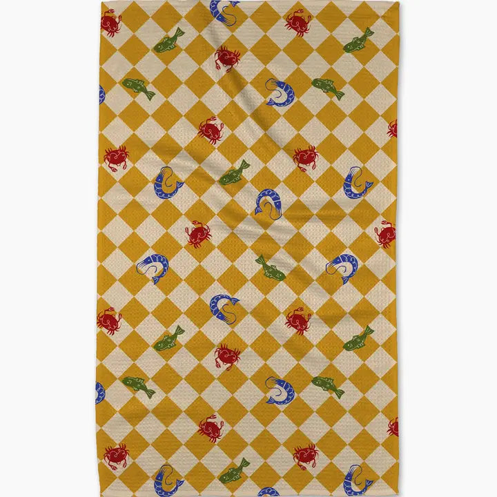 Checkered rug with fish and crab pattern on a yellow and beige background