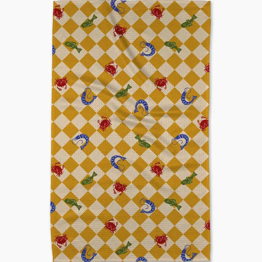 Checkered rug with fish and crab pattern on a yellow and beige background