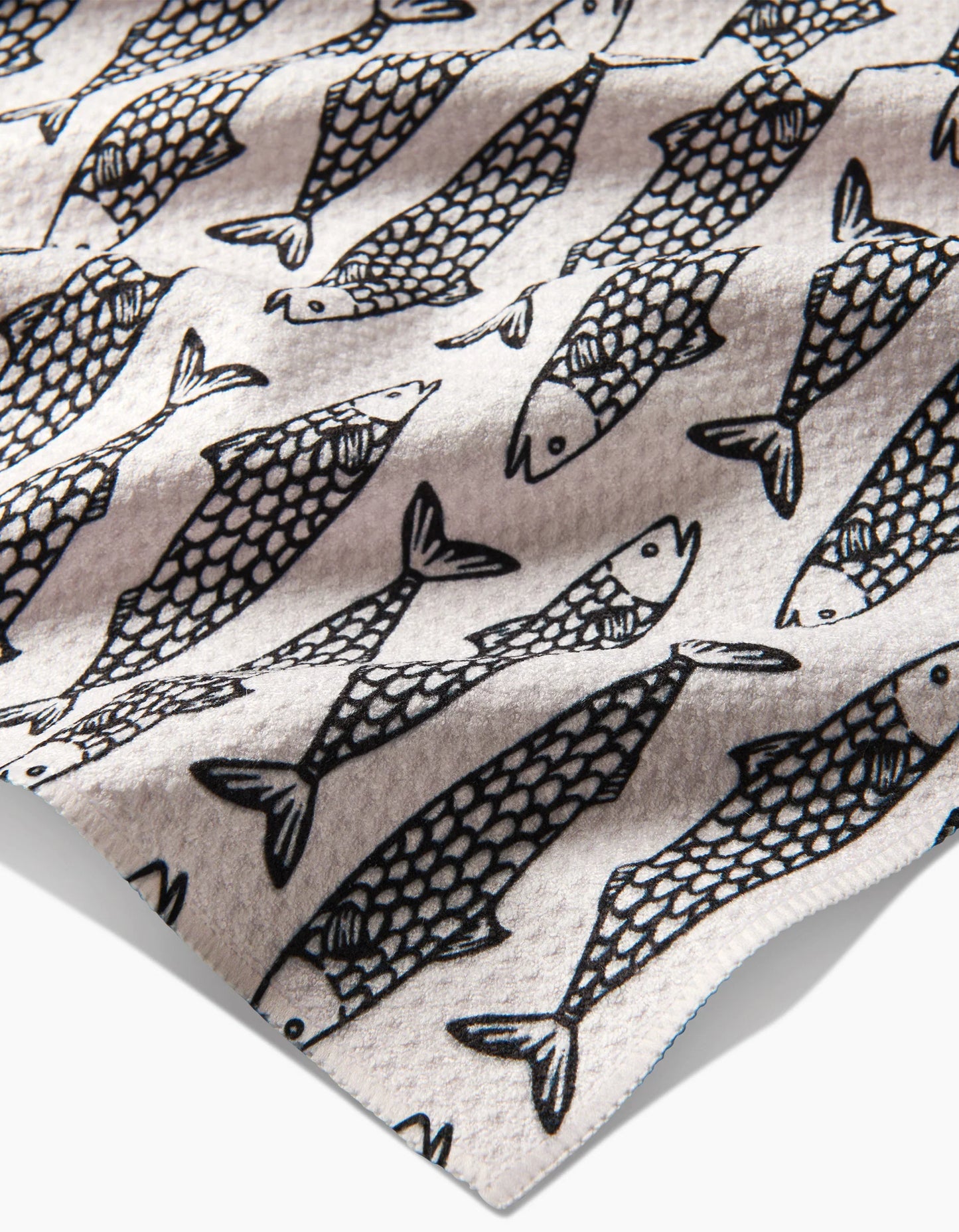 Pattern of black fish outlines on a beige background