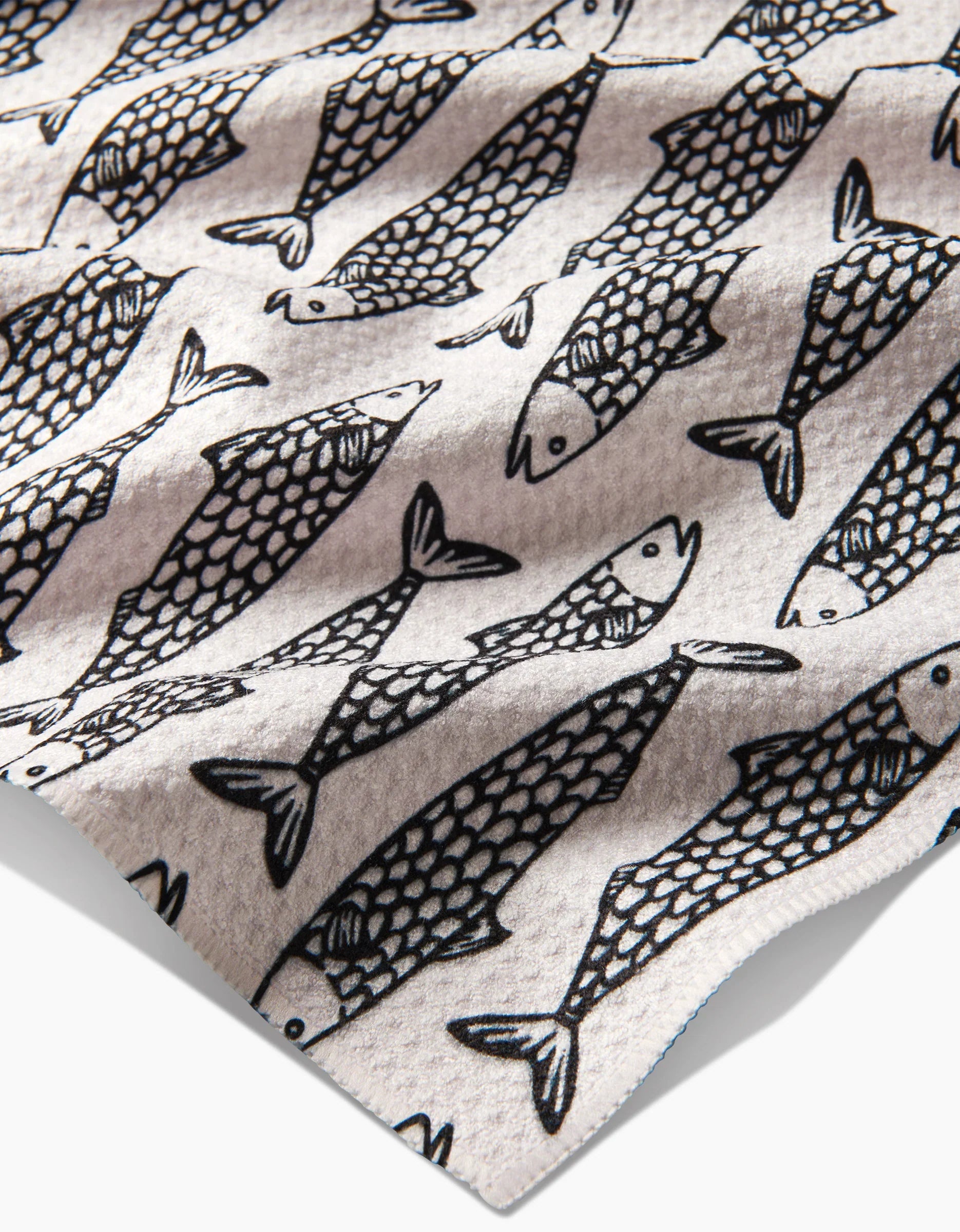 Pattern of black fish outlines on a beige background