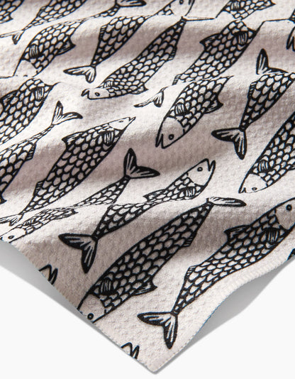 Pattern of black fish outlines on a beige background