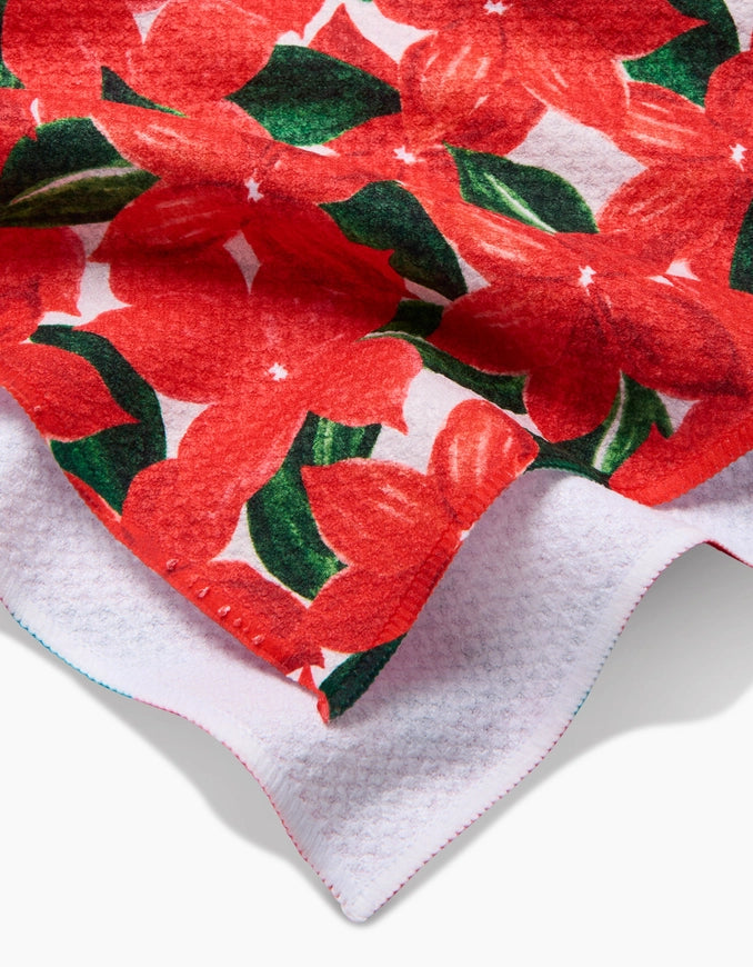 Red floral fabric with green leaves on a white background