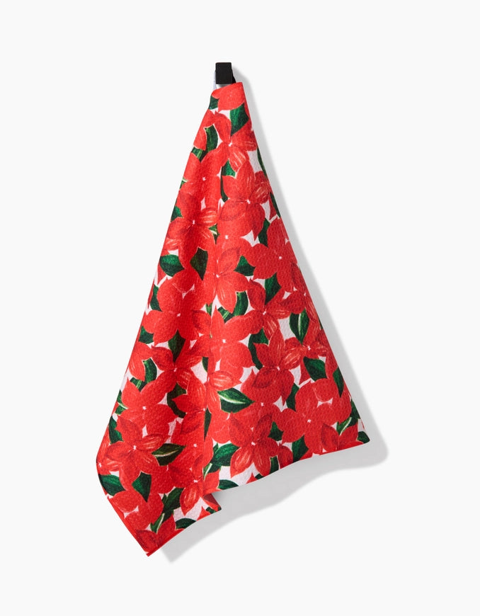 Red floral patterned towel hanging on a white background