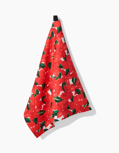 Red floral patterned towel hanging on a white background
