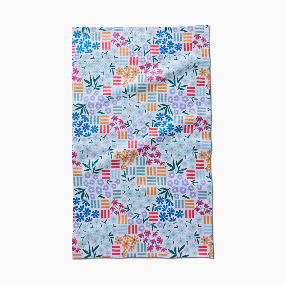 Colorful floral and geometric patterned towel on a white background
