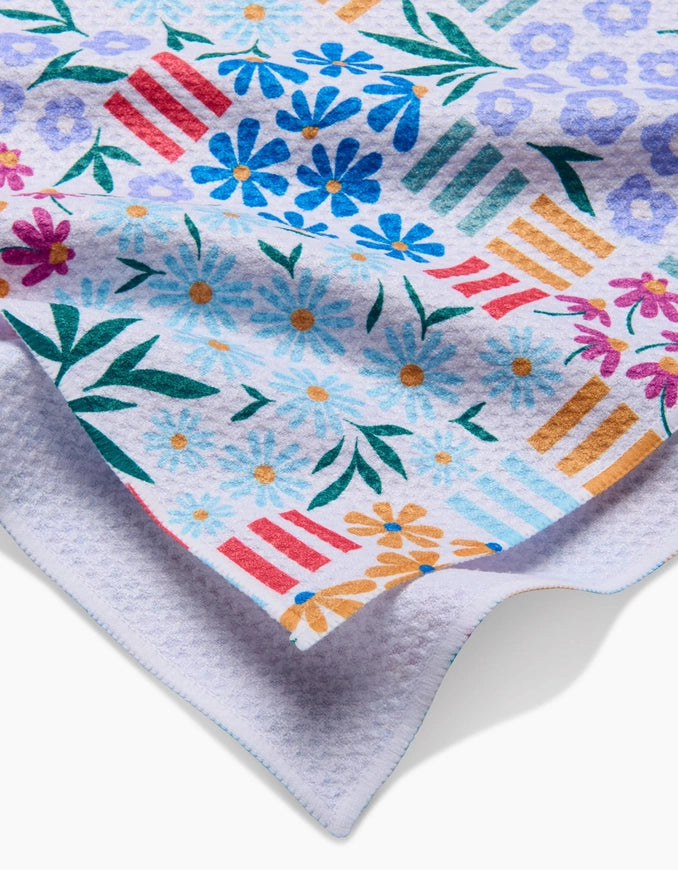 Colorful fabric with floral and geometric patterns on a white background