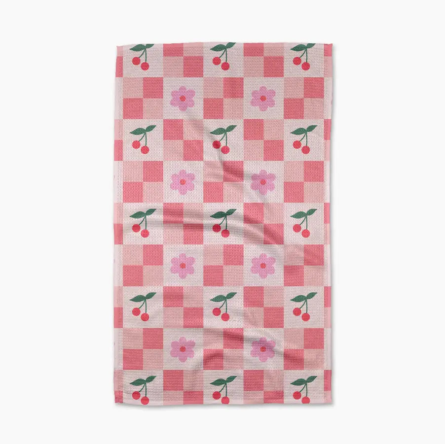 Checkered towel with cherry and flower pattern on a white background
