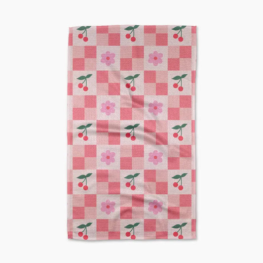 Checkered towel with cherry and flower pattern on a white background