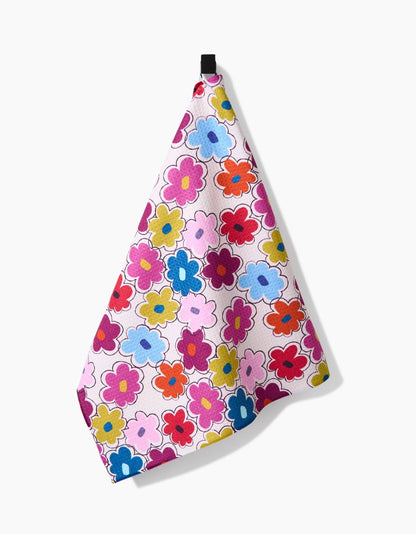 Colorful floral-patterned towel hanging on a white background