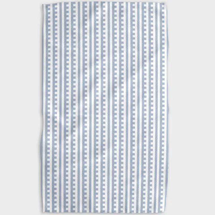 Striped fabric with blue and white pattern on a light gray background