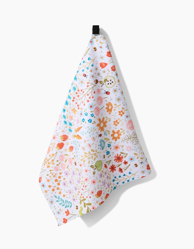 Floral patterned towel hanging on a white background