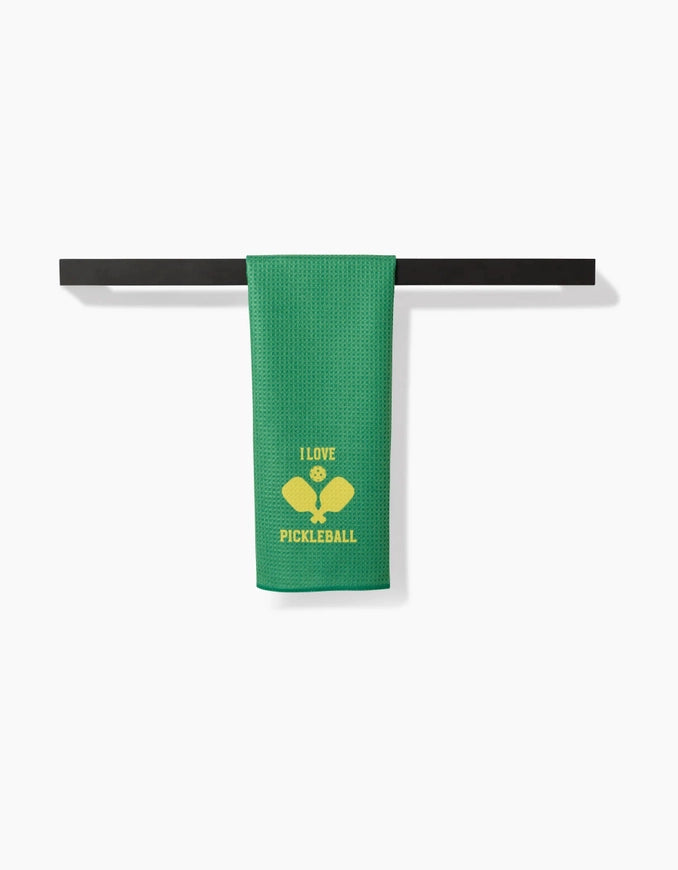 Green towel with 'I love pickleball' text and racquet design on a black bar against a white background
