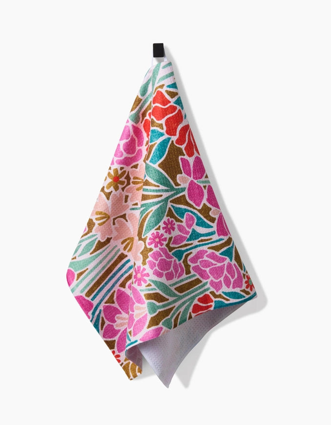 Floral patterned towel hanging on a white background