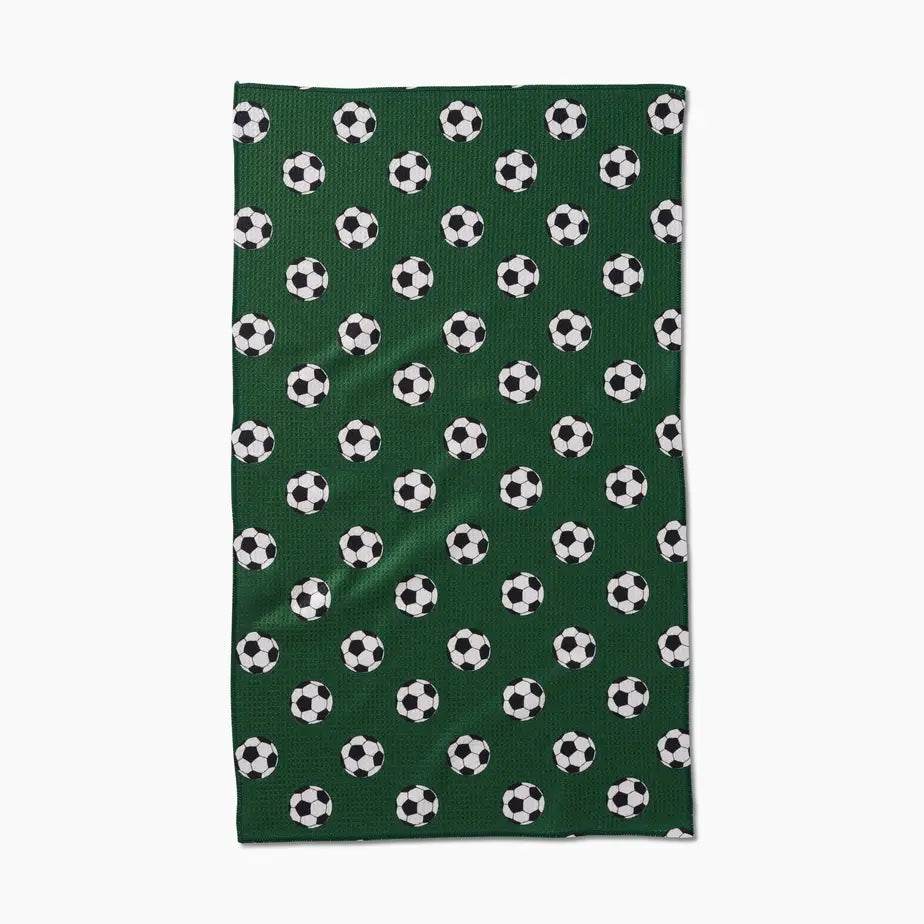 Green towel with soccer ball pattern on a white background