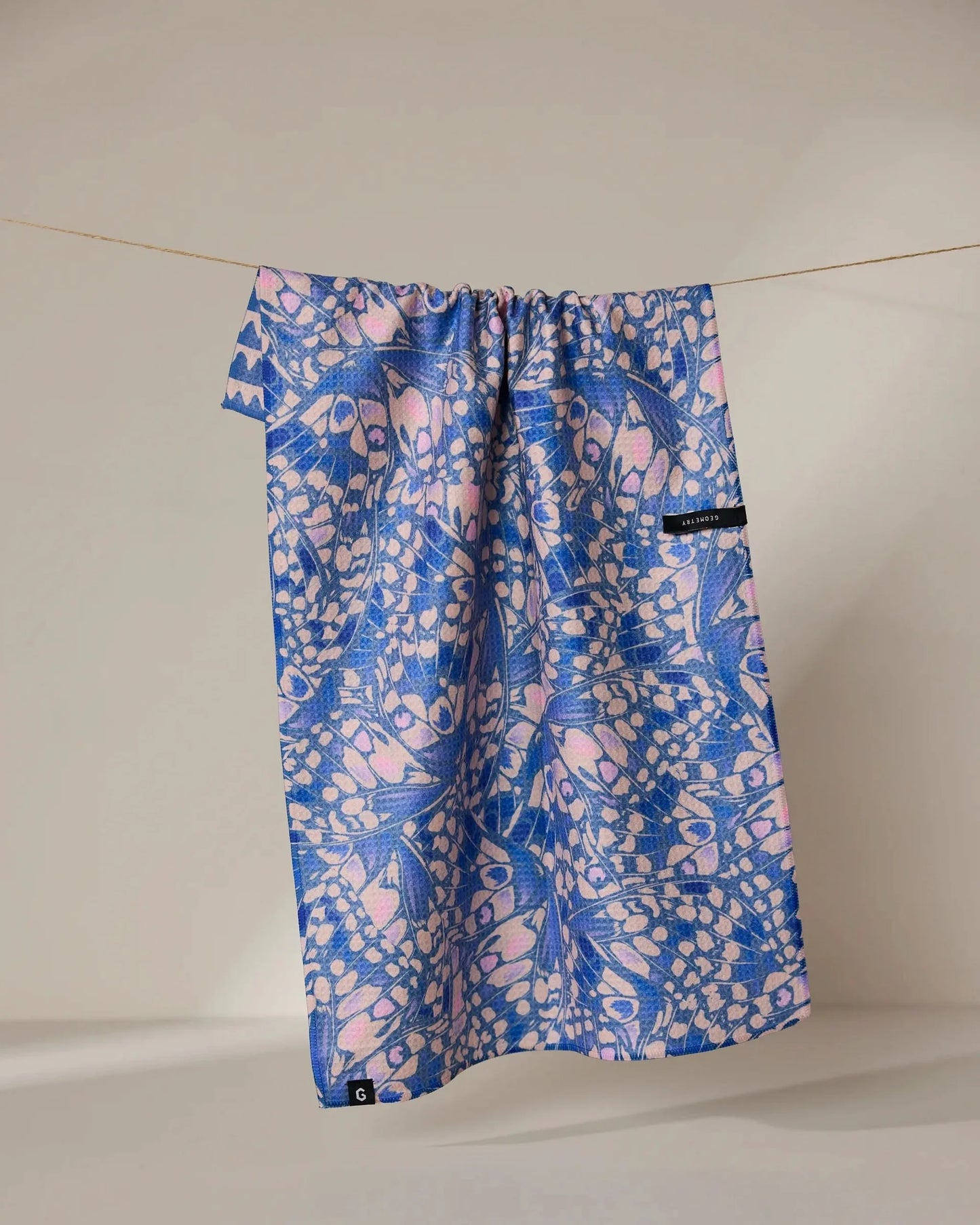 Blue and pink patterned drawstring bag on a white background